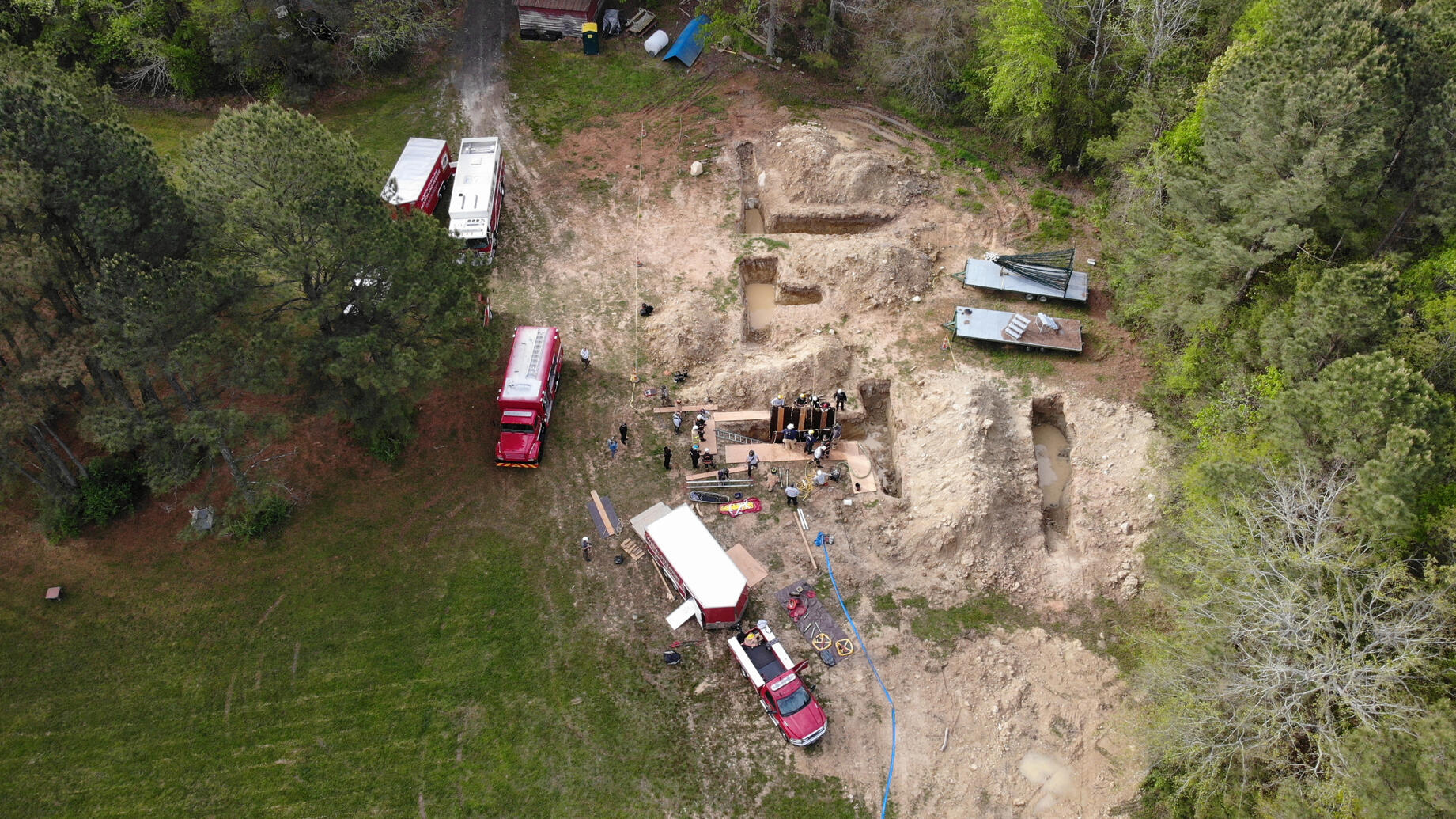 A group of rescuers working on a trench taking from above